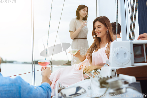 Image of Happy smiling woman drinking vodka cocktails at boat party outdoor, cheerful and happy