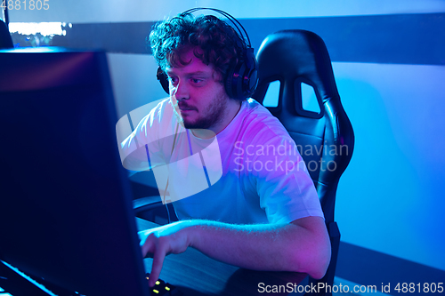 Image of Cyber sport. Fully concentrated professional cybersport player playing important match