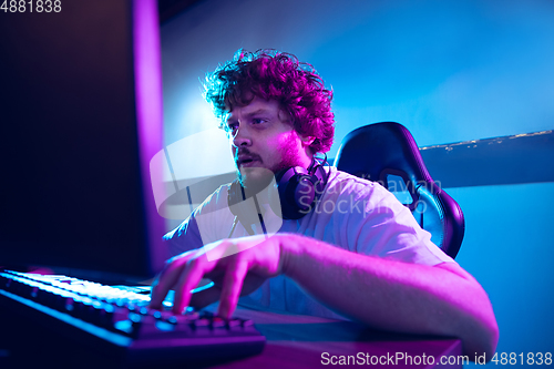 Image of Cyber sport. Fully concentrated professional cybersport player playing important match