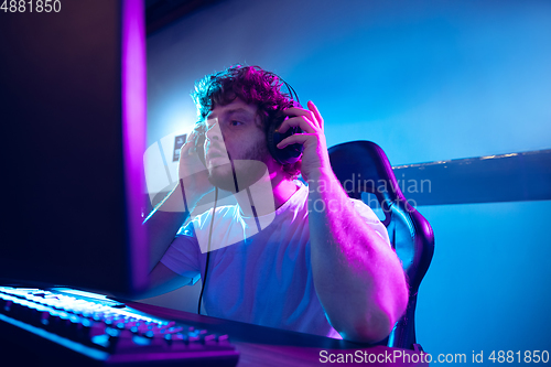 Image of Cyber sport. Fully concentrated professional cybersport player playing important match