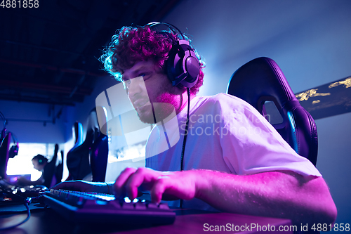 Image of Cyber sport. Fully concentrated professional cybersport player playing important match