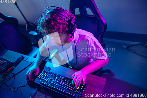 Image of Cyber sport. Fully concentrated professional cybersport player playing important match