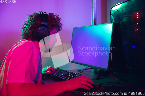 Image of Cyber sport. Fully concentrated professional cybersport player playing important match