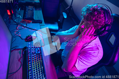 Image of Cyber sport. Fully concentrated professional cybersport player playing important match