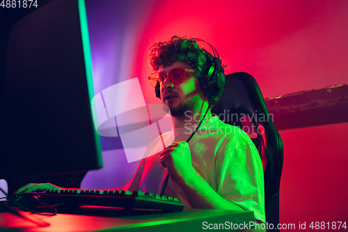 Image of Cyber sport. Fully concentrated professional cybersport player playing important match