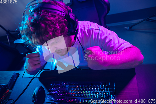 Image of Cyber sport. Fully concentrated professional cybersport player playing important match