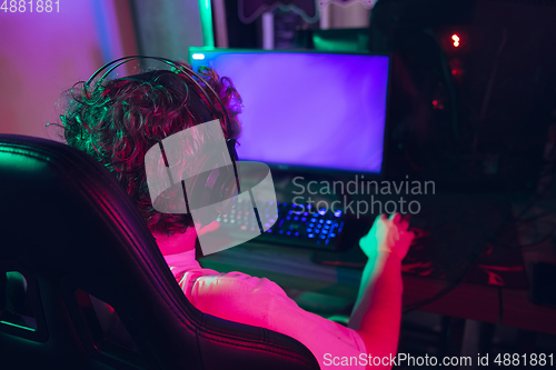 Image of Cyber sport. Fully concentrated professional cybersport player playing important match