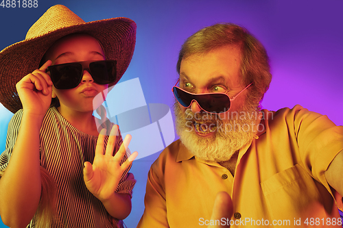 Image of Senior man, grandfather having fun and spending time together with girl, granddaughter. Joyful elderly lifestyle concept