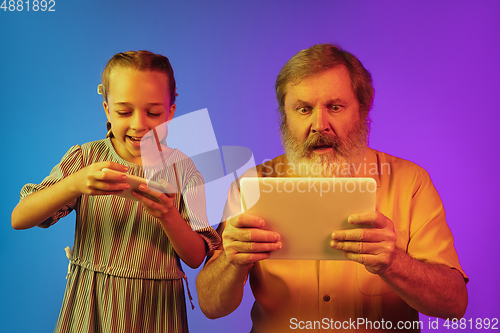 Image of Senior man, grandfather having fun and spending time together with girl, granddaughter. Joyful elderly lifestyle concept