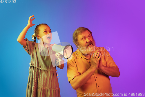 Image of Senior man, grandfather having fun and spending time together with girl, granddaughter. Joyful elderly lifestyle concept