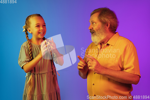 Image of Senior man, grandfather having fun and spending time together with girl, granddaughter. Joyful elderly lifestyle concept