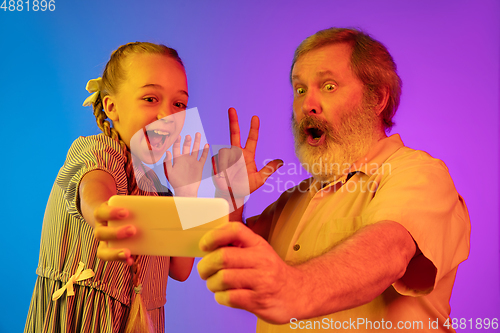 Image of Senior man, grandfather having fun and spending time together with girl, granddaughter. Joyful elderly lifestyle concept