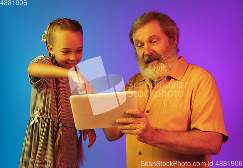 Image of Senior man, grandfather having fun and spending time together with girl, granddaughter. Joyful elderly lifestyle concept