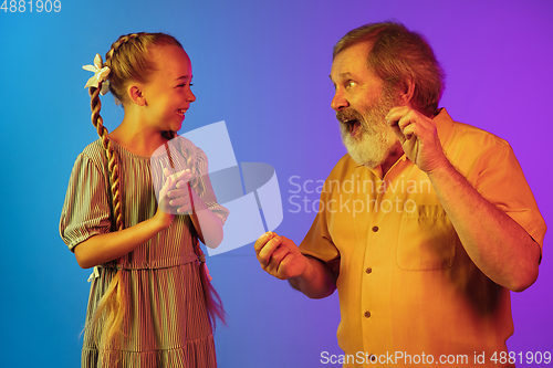Image of Senior man, grandfather having fun and spending time together with girl, granddaughter. Joyful elderly lifestyle concept