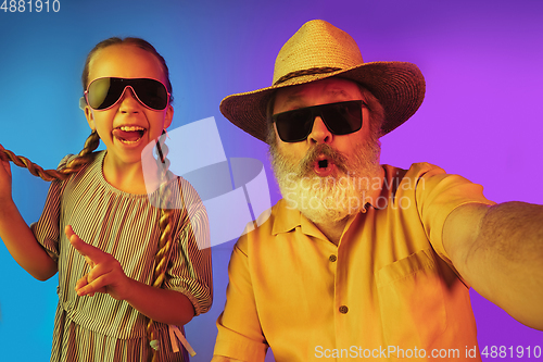 Image of Senior man, grandfather having fun and spending time together with girl, granddaughter. Joyful elderly lifestyle concept