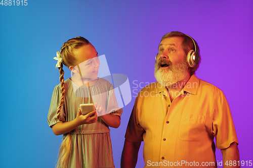 Image of Senior man, grandfather having fun and spending time together with girl, granddaughter. Joyful elderly lifestyle concept