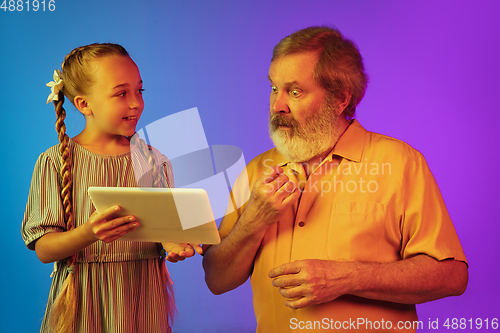 Image of Senior man, grandfather having fun and spending time together with girl, granddaughter. Joyful elderly lifestyle concept