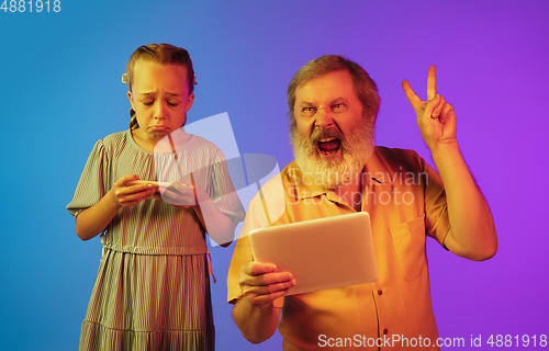 Image of Senior man, grandfather having fun and spending time together with girl, granddaughter. Joyful elderly lifestyle concept