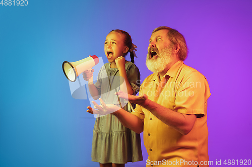 Image of Senior man, grandfather having fun and spending time together with girl, granddaughter. Joyful elderly lifestyle concept