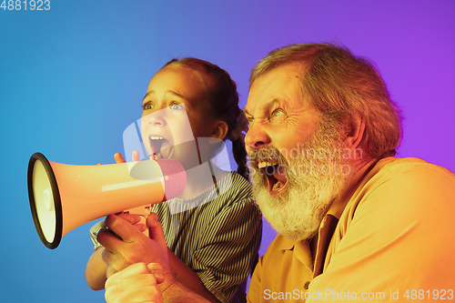 Image of Senior man, grandfather having fun and spending time together with girl, granddaughter. Joyful elderly lifestyle concept