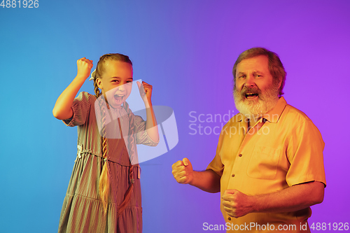 Image of Senior man, grandfather having fun and spending time together with girl, granddaughter. Joyful elderly lifestyle concept