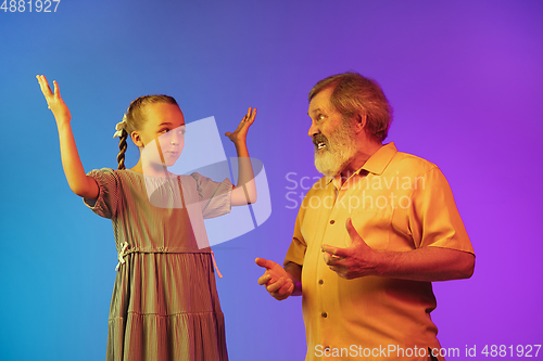 Image of Senior man, grandfather having fun and spending time together with girl, granddaughter. Joyful elderly lifestyle concept