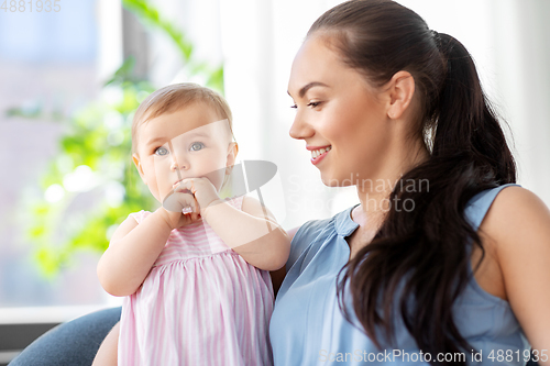Image of happy mother with little baby daughter at home