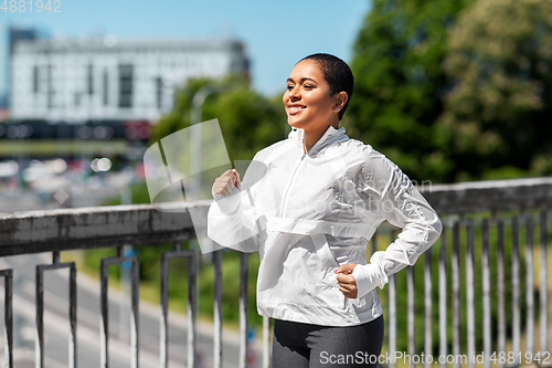 Image of african american woman running outdoors