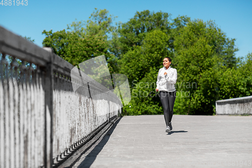 Image of african american woman running outdoors