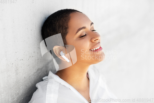 Image of happy african american woman with earphones