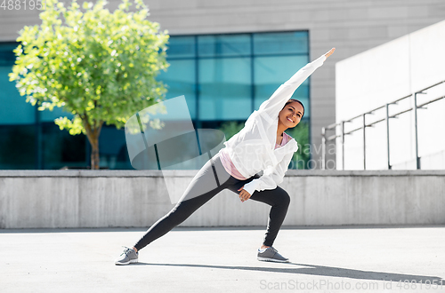 Image of african american woman doing sports outdoors