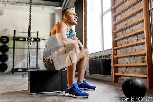 Image of young man with medicine ball in gym