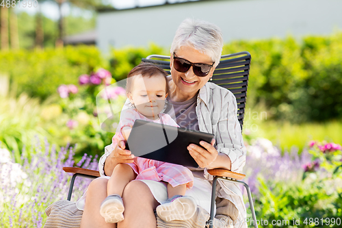 Image of grandmother and baby granddaughter with tablet pc