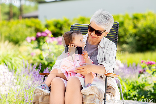 Image of grandmother and baby granddaughter with smartphone