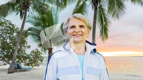 Image of smiling sporty senior woman at summer park