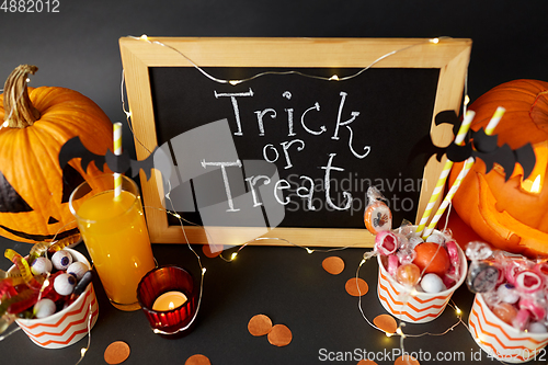 Image of pumpkins, candies and halloween decorations