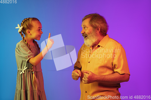 Image of Senior man, grandfather having fun and spending time together with girl, granddaughter. Joyful elderly lifestyle concept