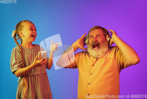 Image of Senior man, grandfather having fun and spending time together with girl, granddaughter. Joyful elderly lifestyle concept