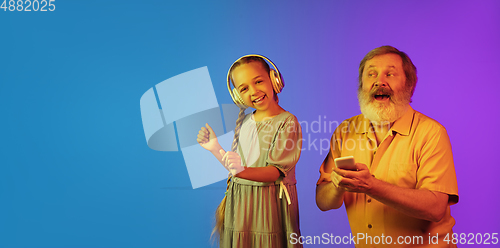Image of Senior man, grandfather having fun and spending time together with girl, granddaughter. Joyful elderly lifestyle concept