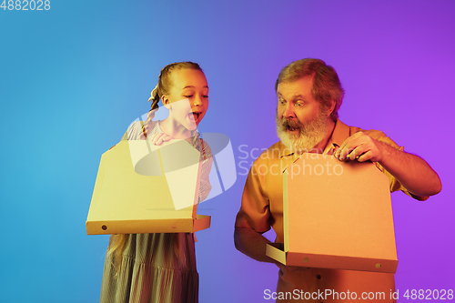 Image of Senior man, grandfather having fun and spending time together with girl, granddaughter. Joyful elderly lifestyle concept