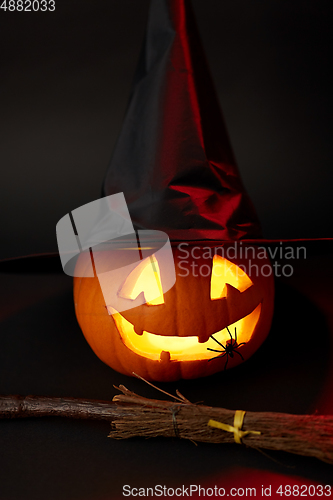 Image of halloween jack-o-lantern in witch's hat and broom