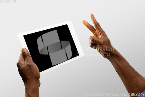 Image of Close up male hands holding smartphone with blank screen during online watching of popular sport matches and championships all around the world. Copyspace for ad