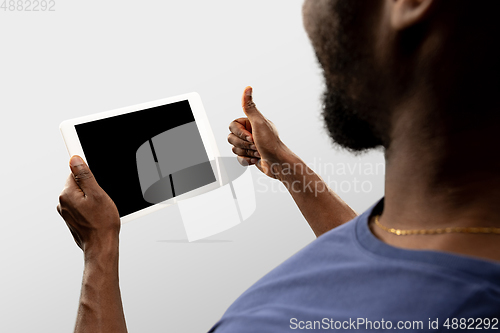 Image of Close up male hands holding smartphone with blank screen during online watching of popular sport matches and championships all around the world. Copyspace for ad