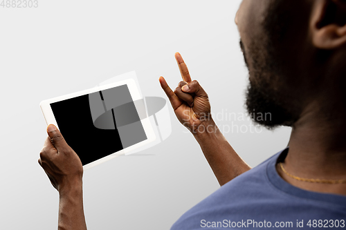 Image of Close up male hands holding smartphone with blank screen during online watching of popular sport matches and championships all around the world. Copyspace for ad