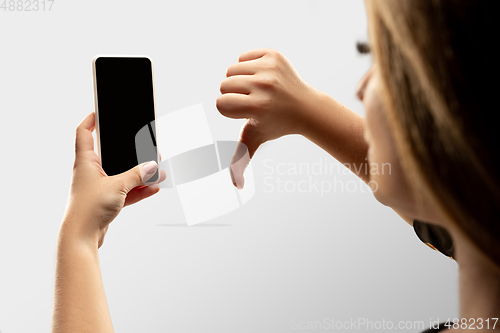 Image of Close up female hands holding smartphone with blank screen during online watching of popular sport matches and championships all around the world. Copyspace for ad