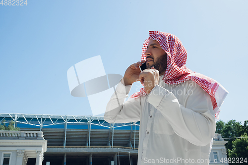 Image of Smiling rich arabian man\'s buying real estate in the city