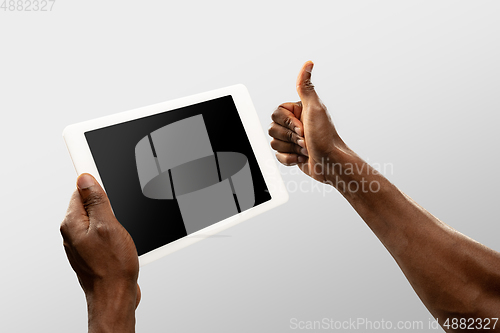 Image of Close up male hands holding smartphone with blank screen during online watching of popular sport matches and championships all around the world. Copyspace for ad