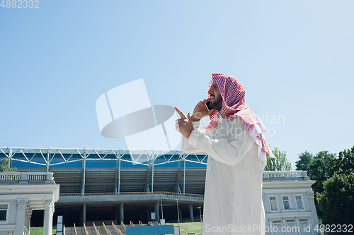 Image of Smiling rich arabian man\'s buying real estate in the city