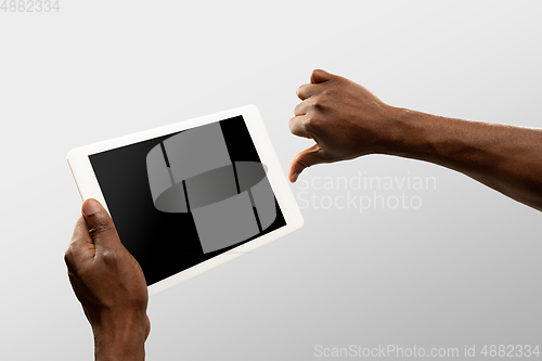 Image of Close up male hands holding smartphone with blank screen during online watching of popular sport matches and championships all around the world. Copyspace for ad