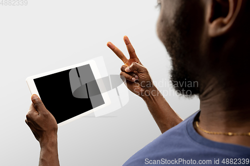 Image of Close up male hands holding smartphone with blank screen during online watching of popular sport matches and championships all around the world. Copyspace for ad